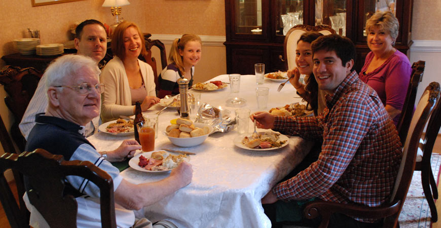 family celebrating thanksgiving dinner
