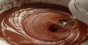 mixing brownie batter with hand mixer