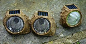 Some solar power lights are disguised as yard features.