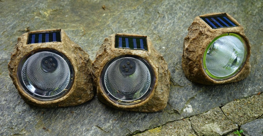 Some solar power lights are disguised as yard features.