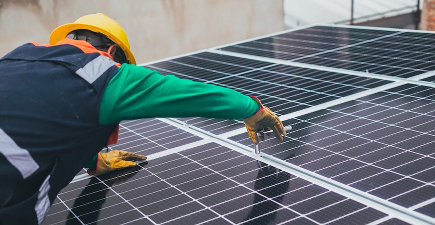 A technician puts together several solar panels